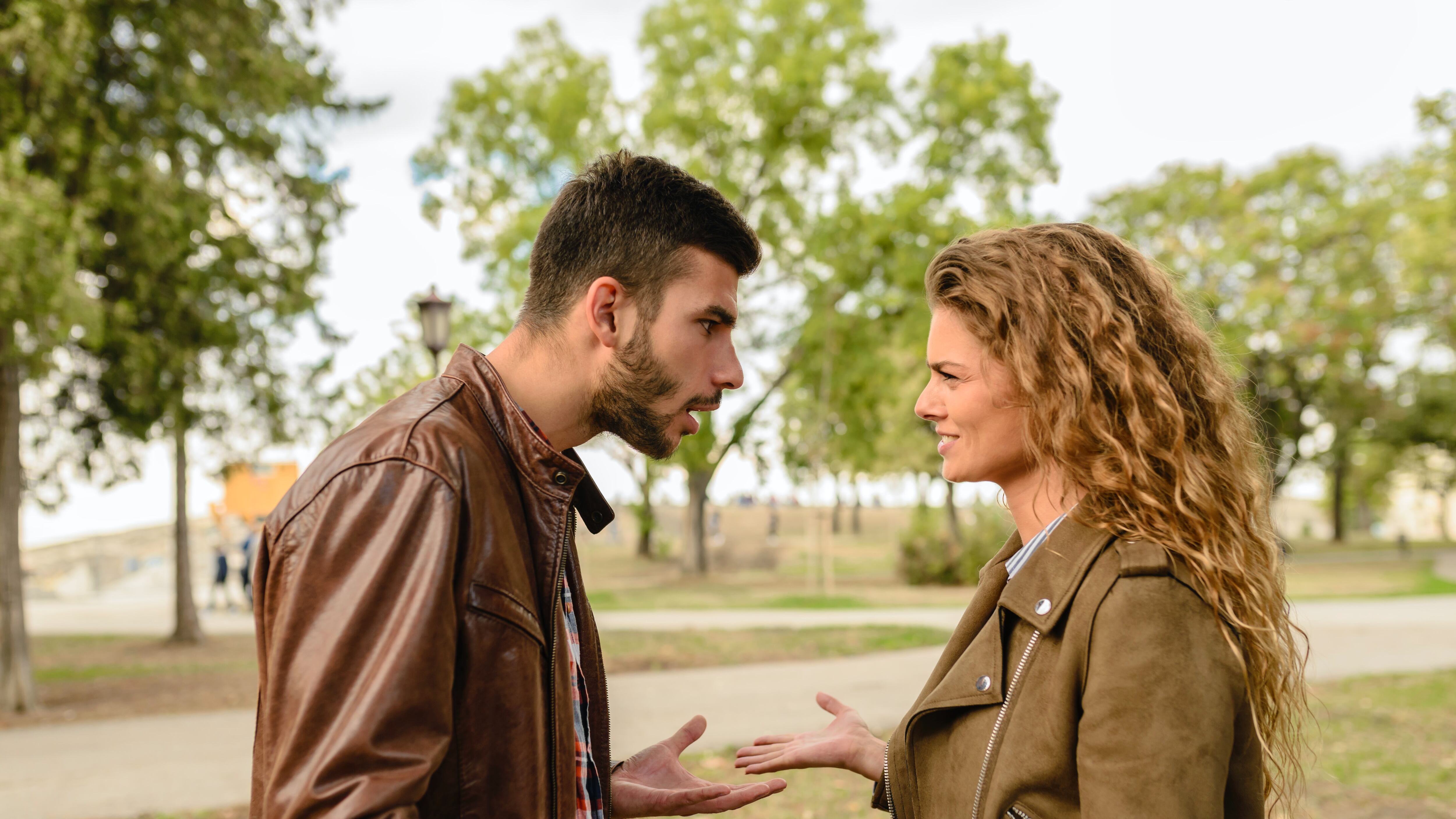 Casal hetero branco discutindo em parque