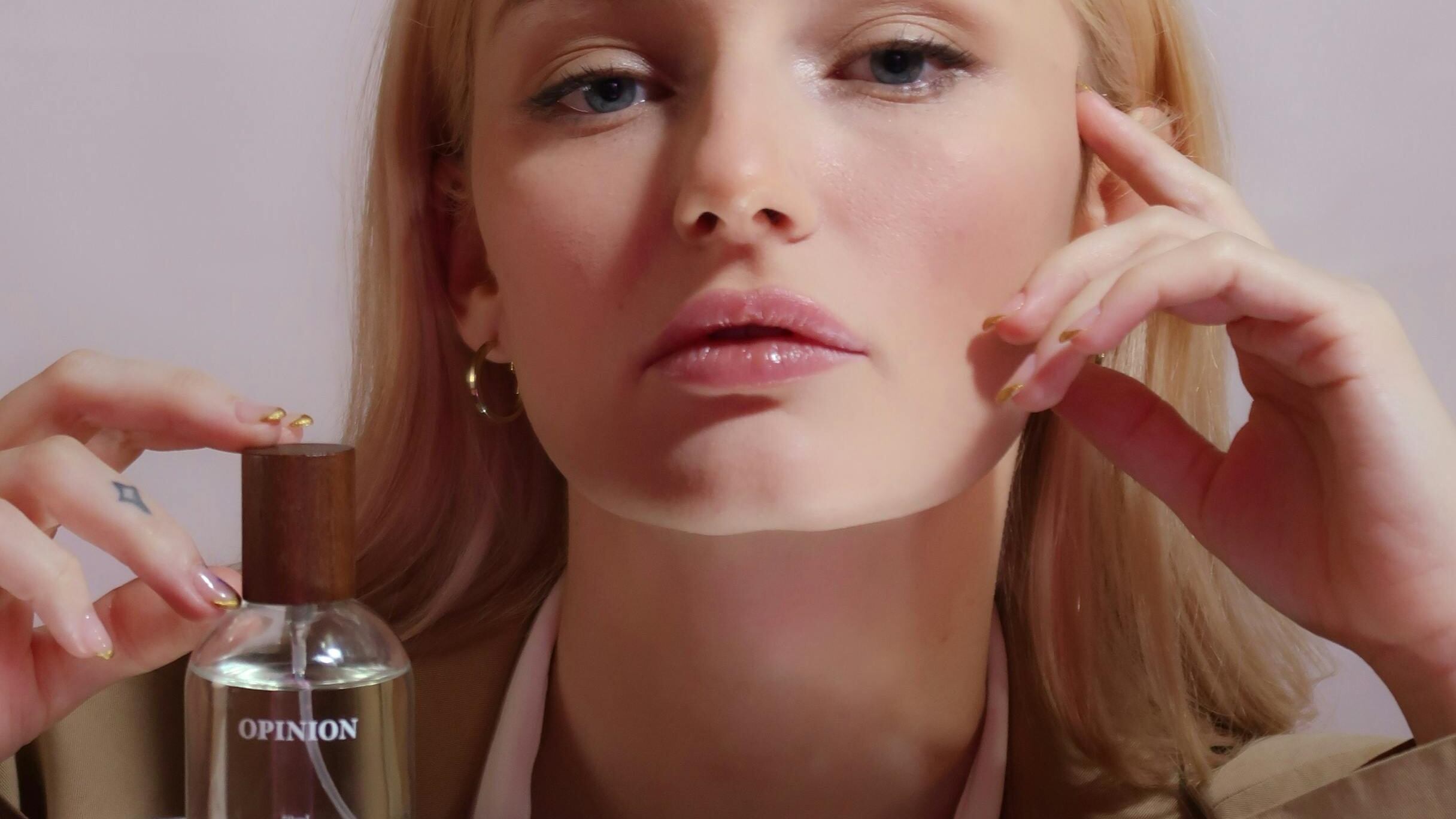 Frasco de perfume Opinion com mulher loira