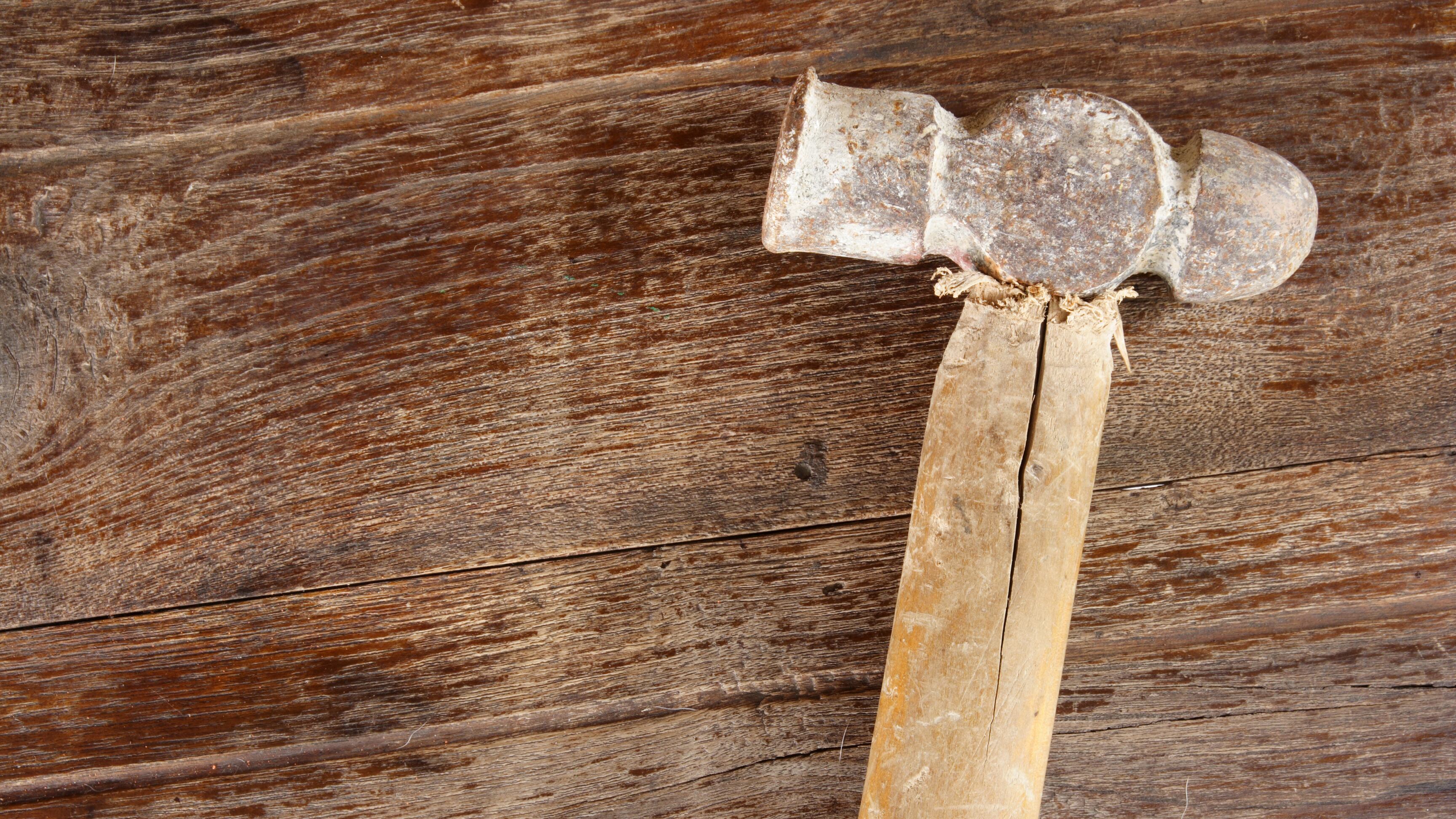 old Hammer on wood background