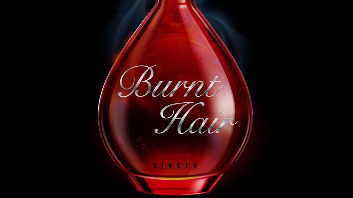 Frasco vermelho de perfume escrito "Burnt Hair".